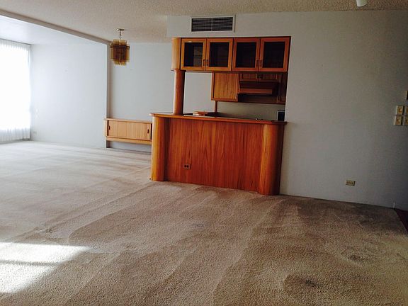 View of living room and dining room off to the left of kitchen