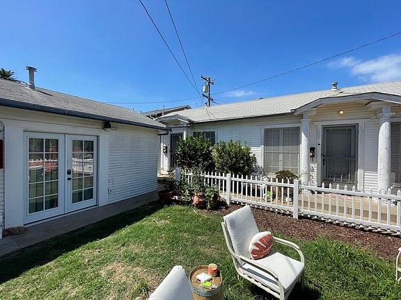 Semi-shared backyard and garage (far left). Both back units are pictured (Unit A on the left and Unit B on the right).