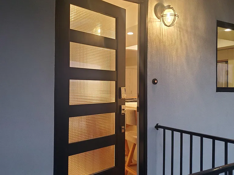 Tuxedo house: white and black with modern architecture, and key less door lock. Cafe lighting on patio.