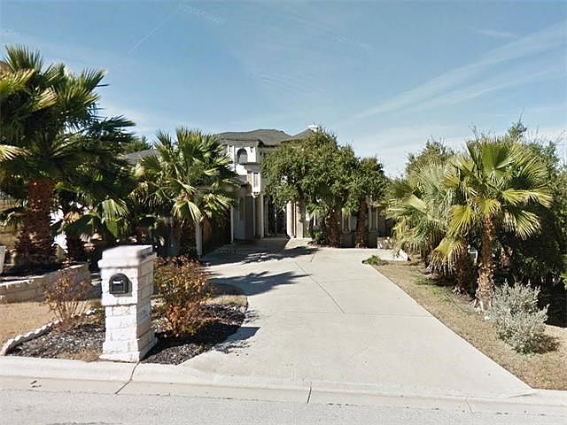 Exterior Front : Detailed stone and stucco exterior with carved stone corinthian columns