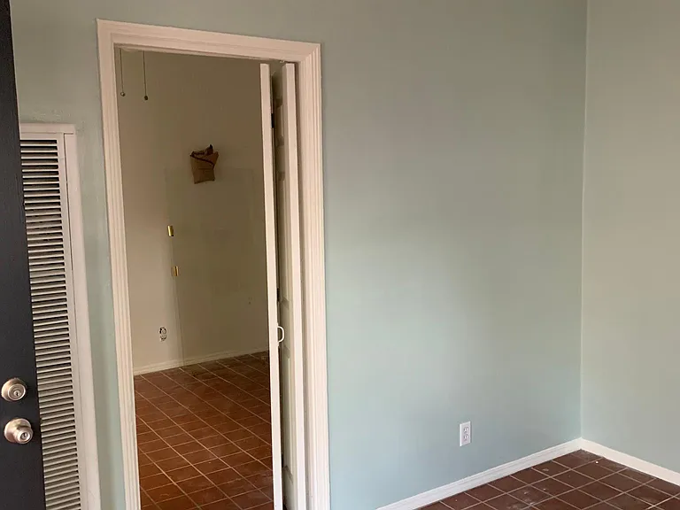 View of bedroom doorway from corner of living room.