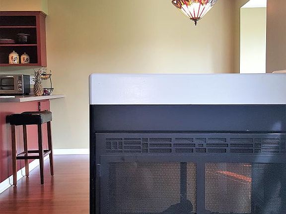 fireplace and view into kitchen