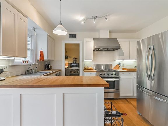 Charming kitchen with subway tile backsplash, butcher block countertops and SS appliances.