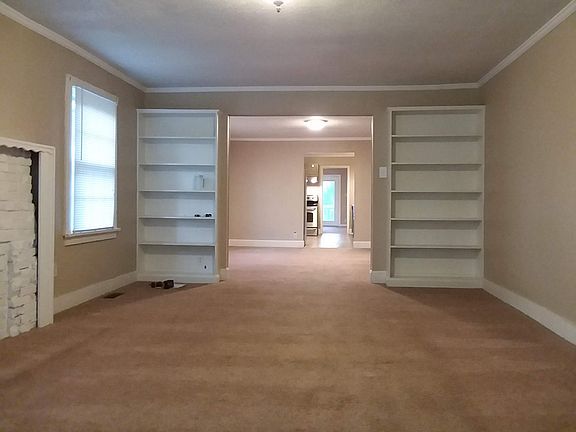 View entering front door, living room, dining room, into kitchen, bonus room at back.