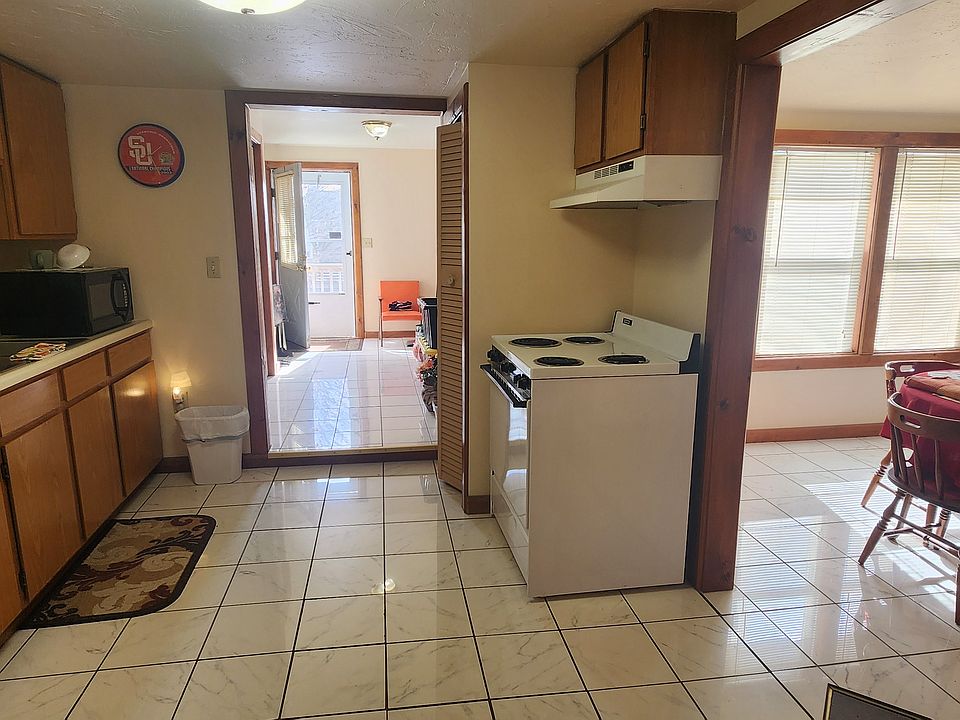 Shows entry way, kitchen, and seperate area for dinning.