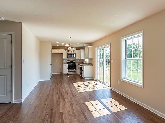 View from family room into dining and kitchen areas - hardwood flooring