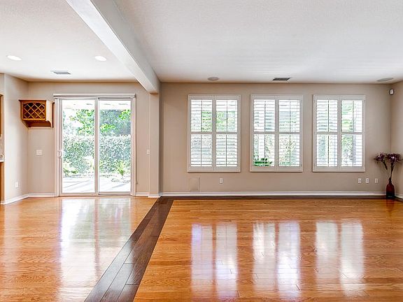 Large Family Room with hardwood floors, opening up to oversize kitchen and serene backyard.
