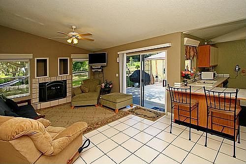 Family Room Boasts Catherdal Ceilings and  Wood Burning Fire Place!