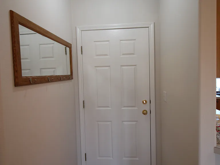 Front door with mirror and coat hooks