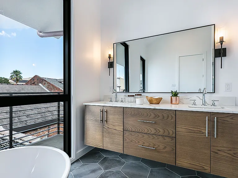 The master bathroom features a double sink vanity and quartz countertops.