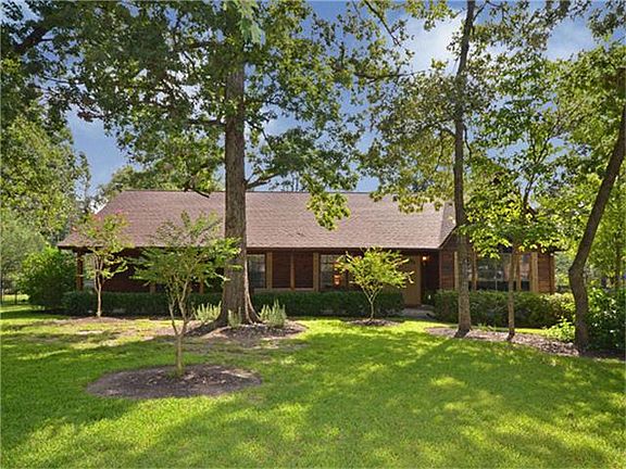 A row of hedges provides abundant privacy to the covered front porch.
