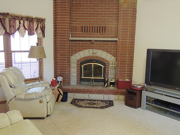 living room with wood burning fireplace.