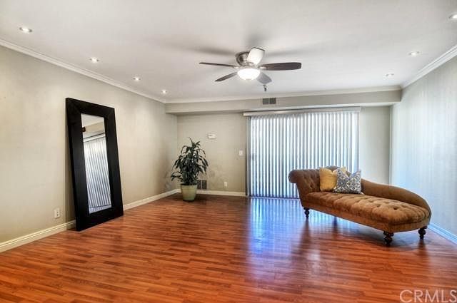 Living room upon entry, sliding glass door leading to balcony