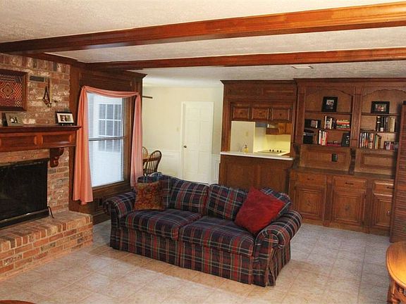 Den features built-ins & 2 large windows looking into huge backyard