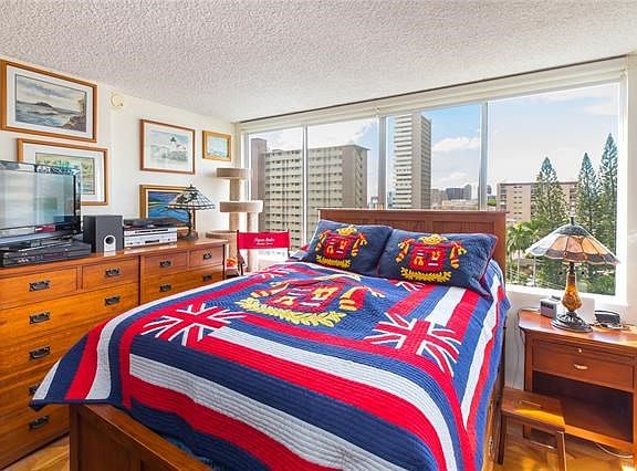 Great city view from the bedroom with large windows and a refreshing breeze. Bedroom also features two closets-one of which is cedar-lined. Owner installed tasteful roll up blinds that are invisible when not in use.