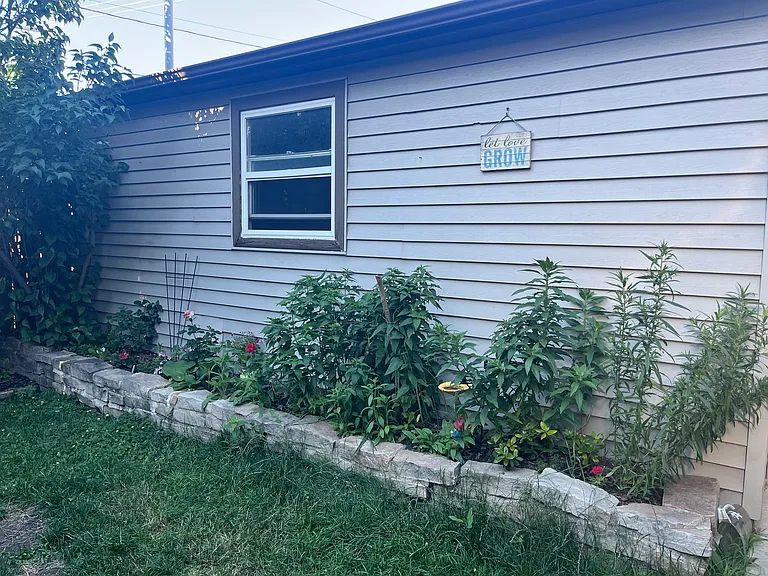 Picture garden along the garage in the backyard.
