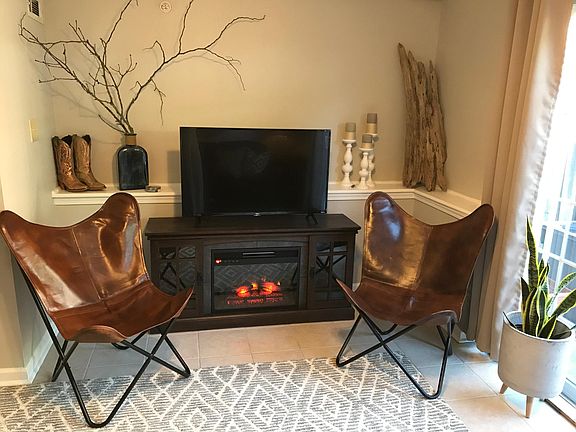 The living room is made cozier with an electric fireplace.