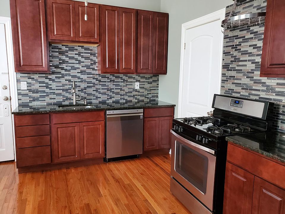 Kitchen towards main bedroom. Door to house hallway on the left.