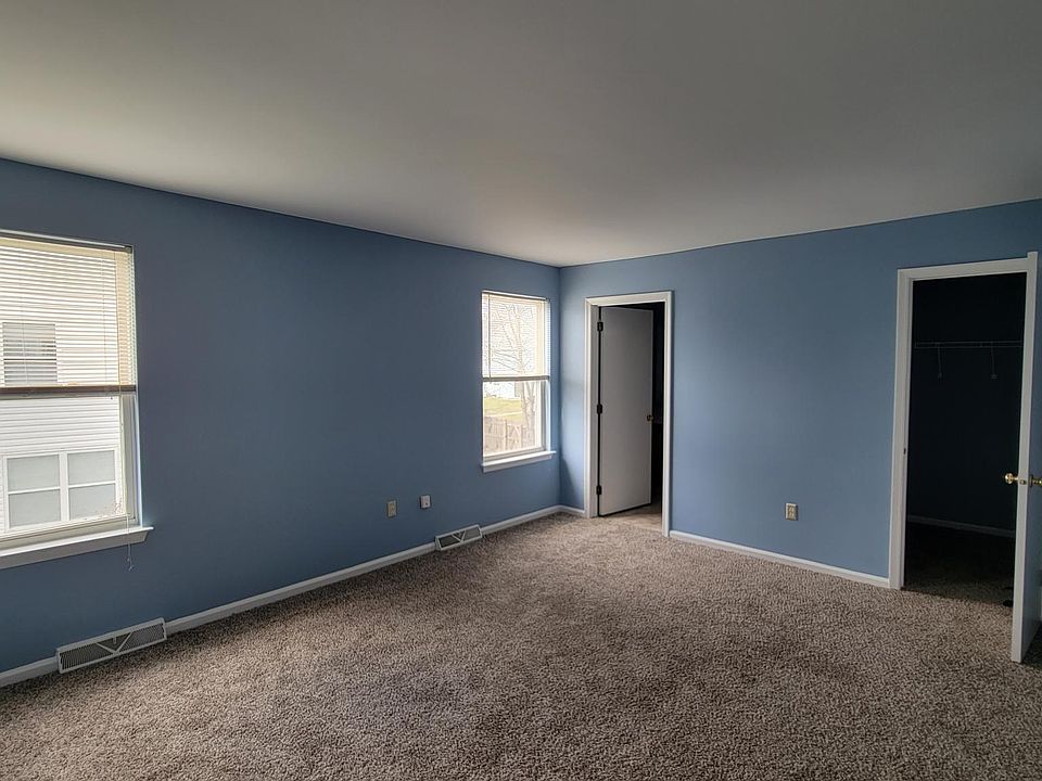 Master bedroom with door to walk in closet and bathroom with shower and toilette
