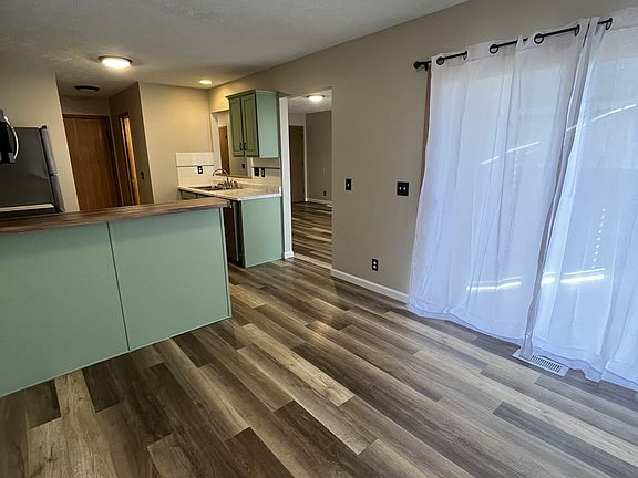 Sliding patio door leading to fully fenced backyard