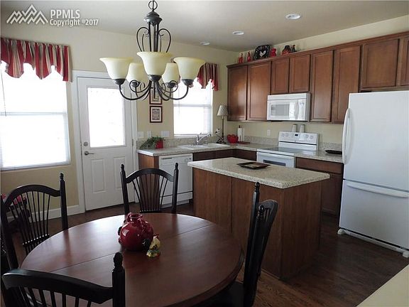 Spacious kitchen with hard wood floors, island, granite surface counters. Exteri