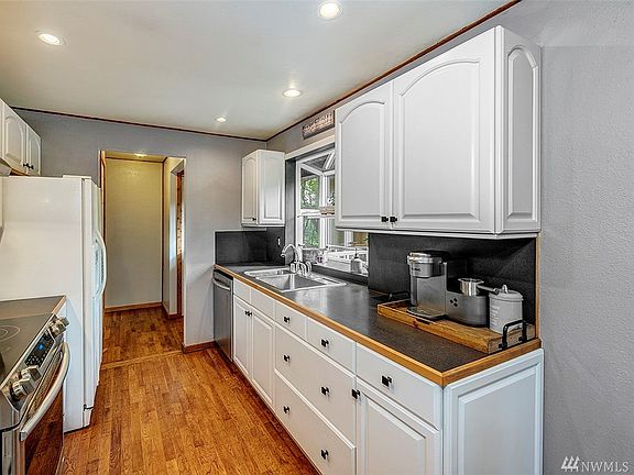 Crisp white cabinets and the garden window make this a great place to cook.
