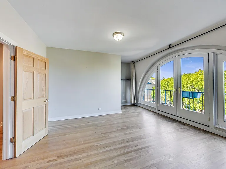 Primary bedroom floor to ceiling windows.