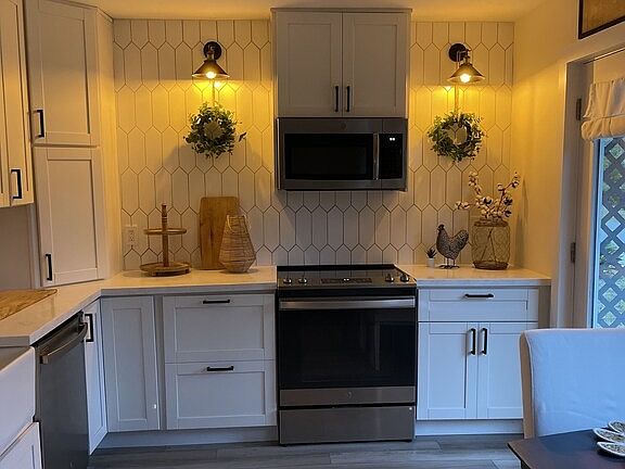 Pendant lighting is on a dimmer switch for a warm moody feel inside the kitchen.