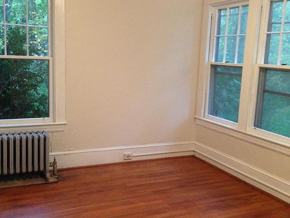 Bedroom with lots of windows and original hardwood floors