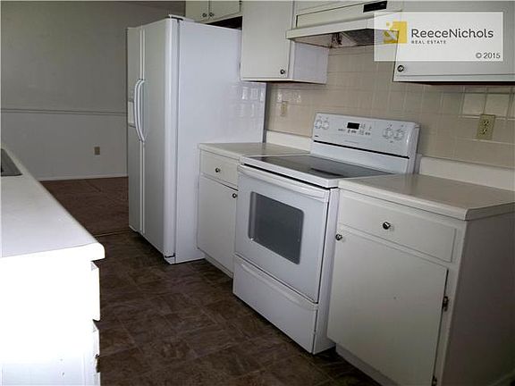 Another view of Walk Thru Kitchen with newer vinyl flooring and
