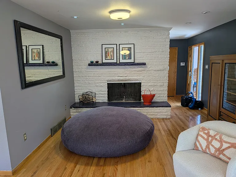 Living Room has wood burning fireplace and 2 seating areas.