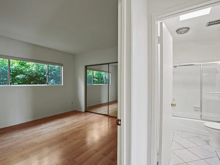 Bedroom with Bathroom, Closet, and Windows