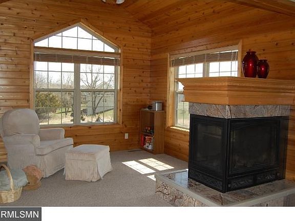 Main floor sun room shares the 3 sided fireplace