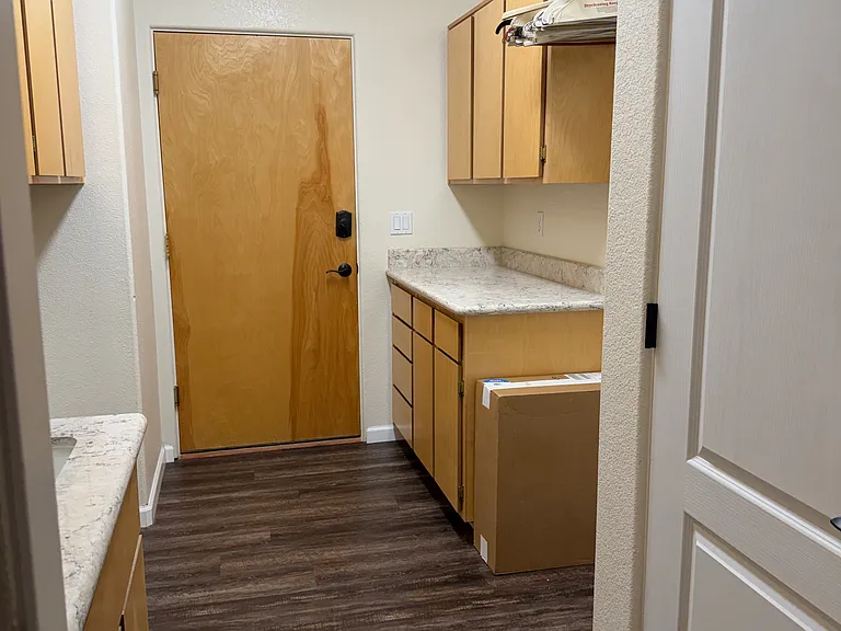 Laundry room with storage, sink, washer and dryer hookups