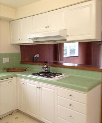 The kitchen has a gas stove and a breakfast bar