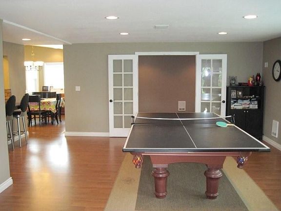 Rec room with media room behind french doors.