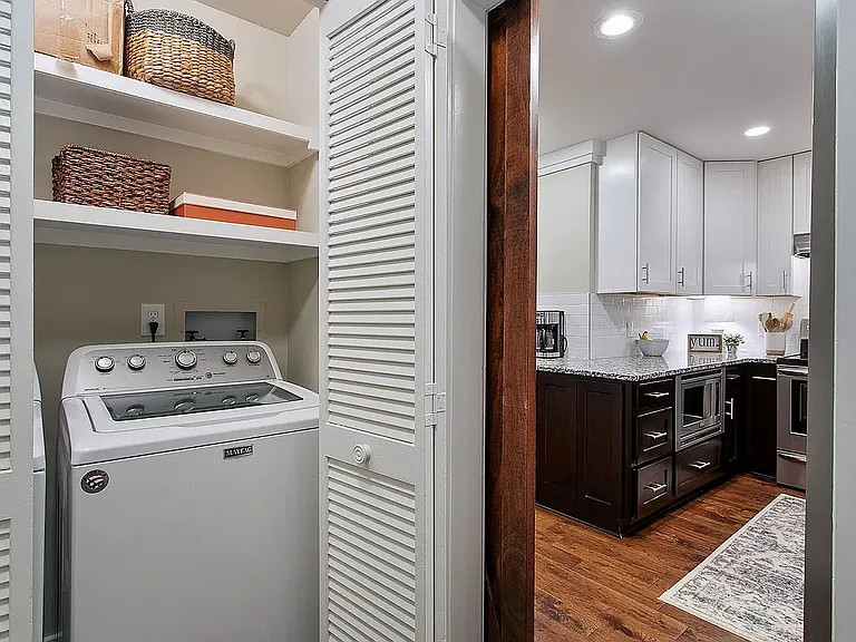 Separate laundry area with storage pantry