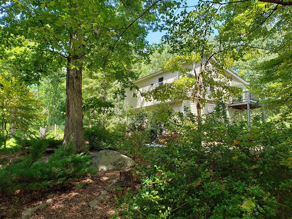2 story Forest House amid mature landscaping