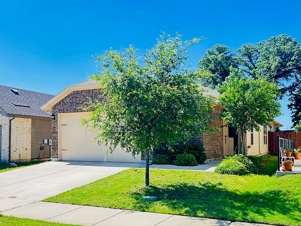 The home welcomes you with charming curb appeal, featuring a covered entryway, and a classic brick-and-siding exterior.