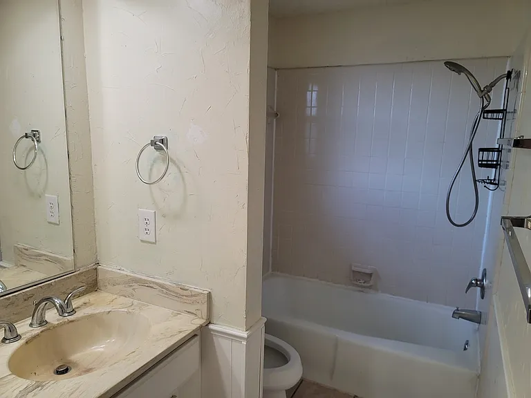 Upstairs guest bathroom with shower and tub and double vanity.