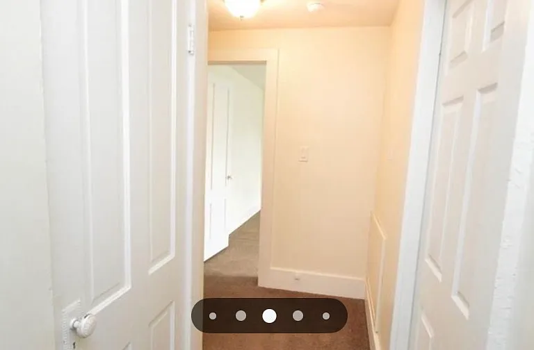 Top of stairs on second floor looking down hallway towards 2nd and 3rd bedrooms. 1st bedroom directly behind photo.