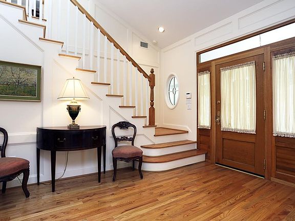 Beautiful and spacious entry. Antique door with custom built side panels and transom.