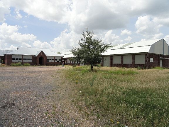 Exterior brick building with new metal roofs