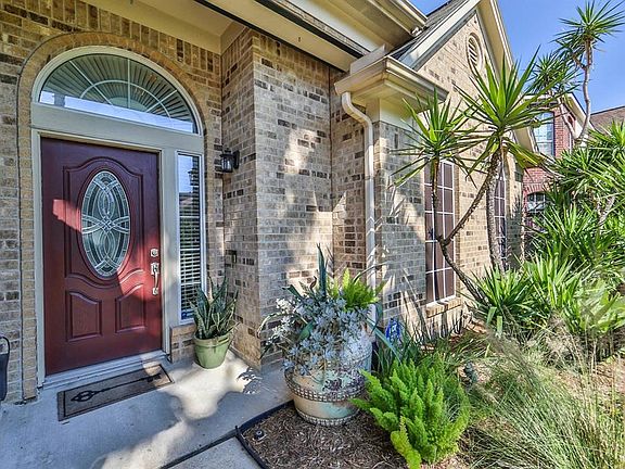 Pretty front door and lush landscaping