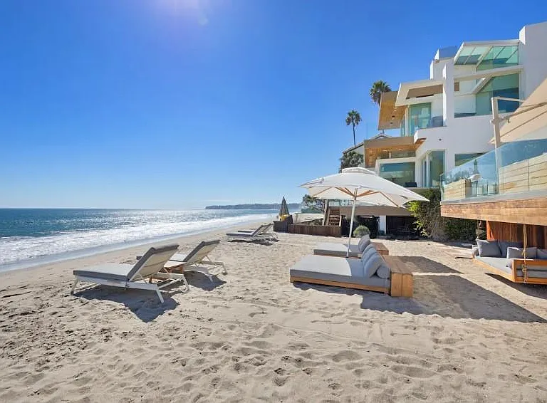 Luxurious beach sun loungers and outdoor umbrellas on the beach.
