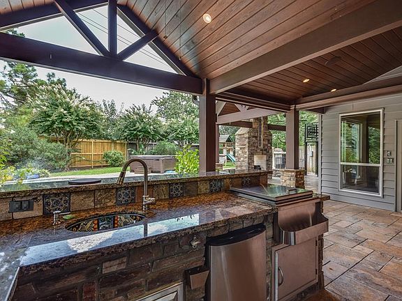 Entertaining in the outdoor kitchen will be a breeze with all the features this space offers, the outdoor sink, serving bar, lots of counter space, bar refrigerator, bbq and still plenty of space to mingle.