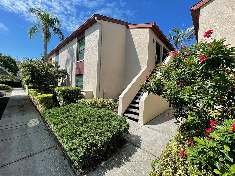Sidewalk view of building exterior and front entrance to home.