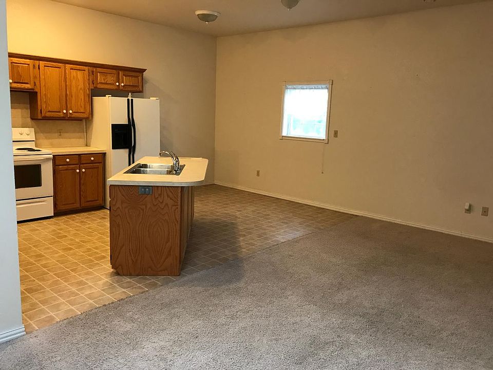 Kitchen side view with small dining area and window