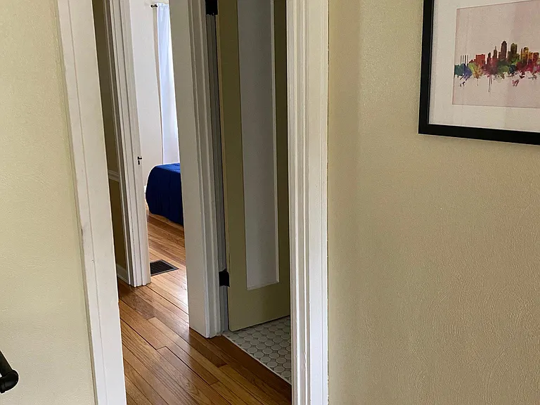 Hallway that leads to pantry/linen closet, bathroom and 3 bedrooms.