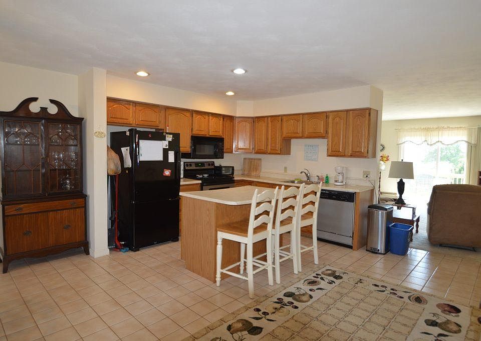 Up the stairs on the second floor is the open kitchen/dining room with living room and private deck